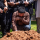 Altaf Hussain cries over the grave of his brother Aftab Hussein at Fairview Memorial Park in Albuquerque, N.M., on Friday, Aug. 5, 2022. A funeral service was held for Aftab Hussein, 41, and Muhammad Afzaal Hussain, 27, at the Islamic Center of New Mexico on Friday. Both Muslim men were shot and killed near their homes only six days apart. Law enforcement believes one suspect could be responsible for killing three Muslim men in the past nine months.